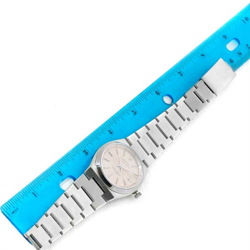 The Vintage Collection Rolex watch is shown flat with its face, bracelet, and clasp visible alongside a ruler for scale.