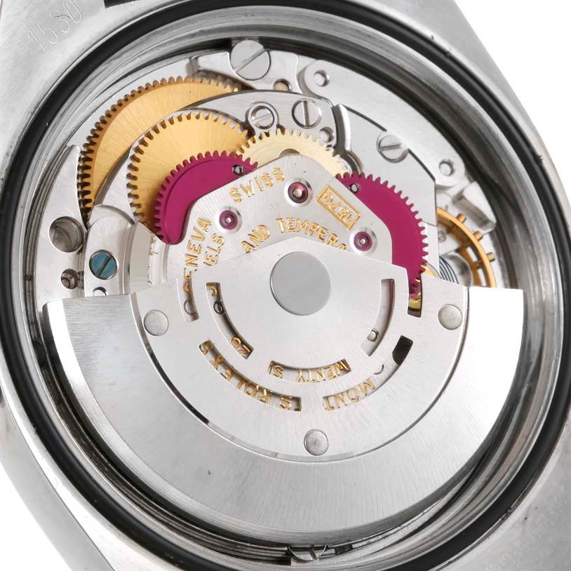 The image shows the intricate inner mechanism and gears of a Vintage Collection model by Rolex from a top-down angle.