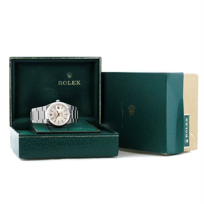 The image displays a Rolex Vintage Collection 1530 Men's Stainless Steel Silver Dial 1530 Men's Stainless Steel Silver Dial watch, shown from a frontal angle, with its box and outer packaging.