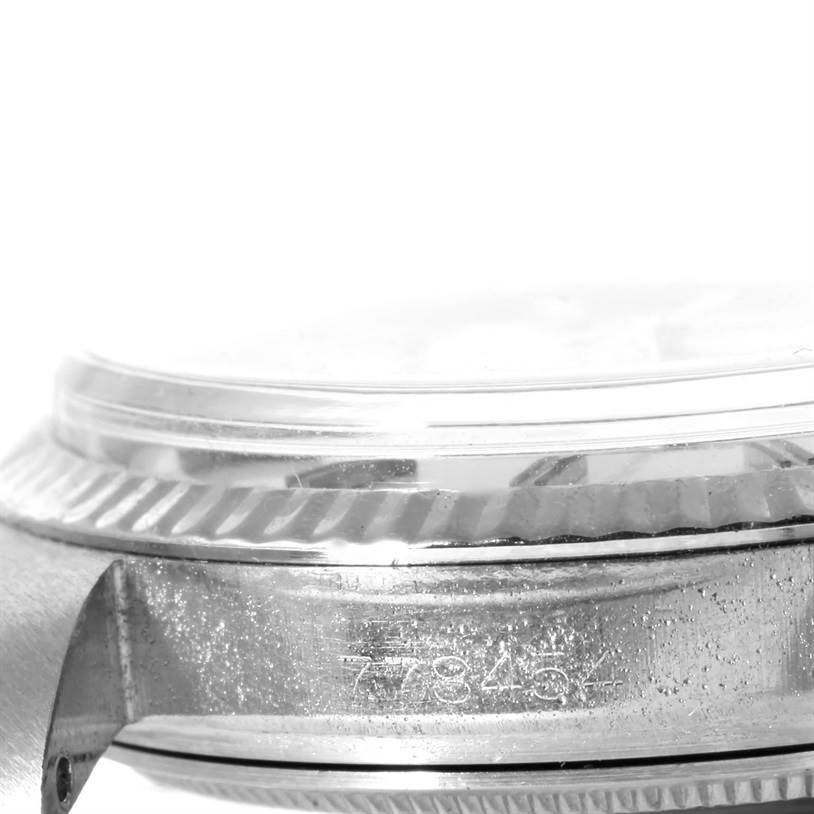 The image shows a close-up side view of the case and bezel of a Vintage Collection Rolex watch, including the serial number.