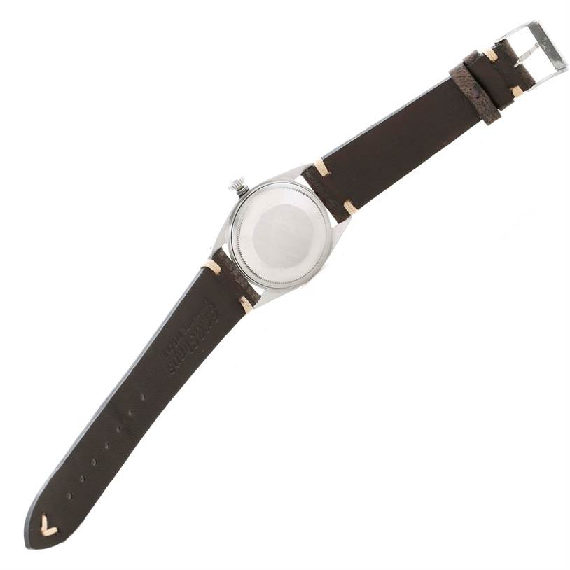 The image shows the back view of a Rolex Vintage Collection 1601 Men's Stainless Steel Silver Dial 1601 Men's Stainless Steel Silver Dial watch with a brown leather strap and stainless steel case.