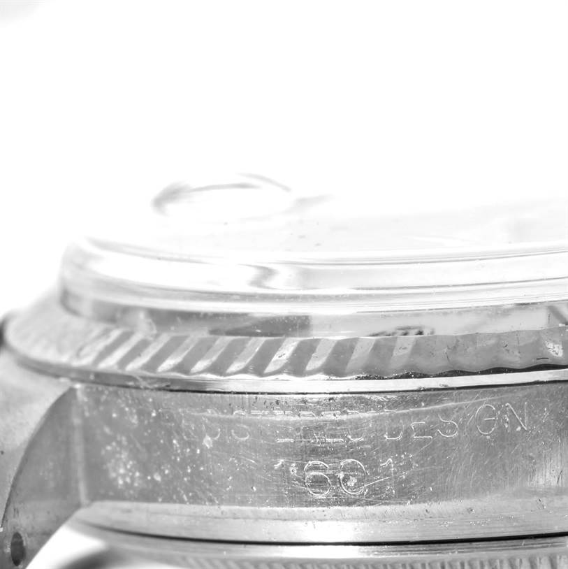 The image shows a close-up, side view of the bezel and crystal of the Rolex Vintage Collection 1601 Men's Stainless Steel Silver Dial 1601 Men's Stainless Steel Silver Dial model.