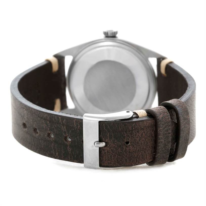 The image shows the back view of a Rolex Vintage Collection 1601 Men's Stainless Steel Silver Dial 1601 Men's Stainless Steel Silver Dial watch, highlighting its clasp and leather strap.