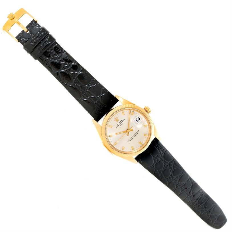 The image shows a Vintage Collection Rolex watch at an angle displaying its face, black leather strap, and gold buckle.