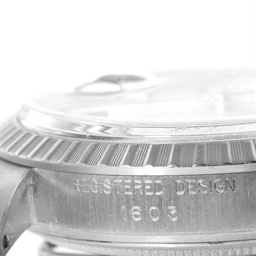 The image shows a side angle of the bezel and engraved case of the Rolex Vintage Collection 1603 Men's Stainless Steel Silver Dial 1603 Men's Stainless Steel Silver Dial model 1603.