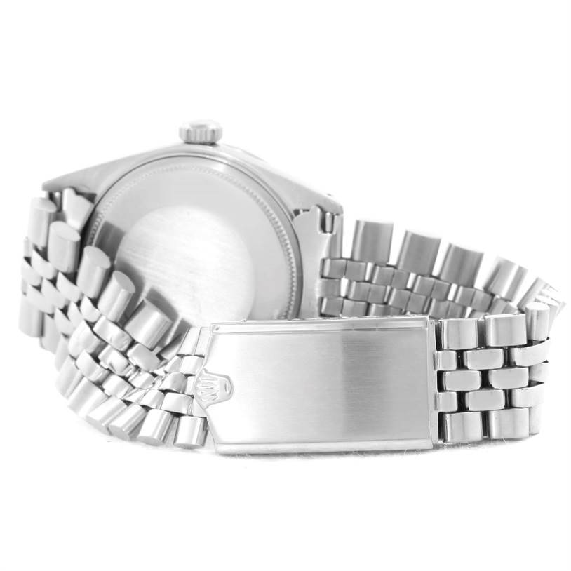 The image shows the back case and a portion of the bracelet of a Rolex Vintage Collection 1603 Men's Stainless Steel Silver Dial 1603 Men's Stainless Steel Silver Dial watch.