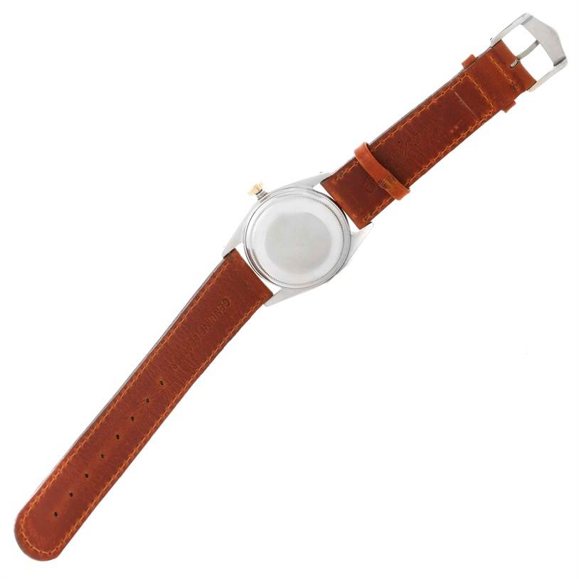 The image shows a top-down view of the back and brown leather strap of a Vintage Collection model Rolex watch.