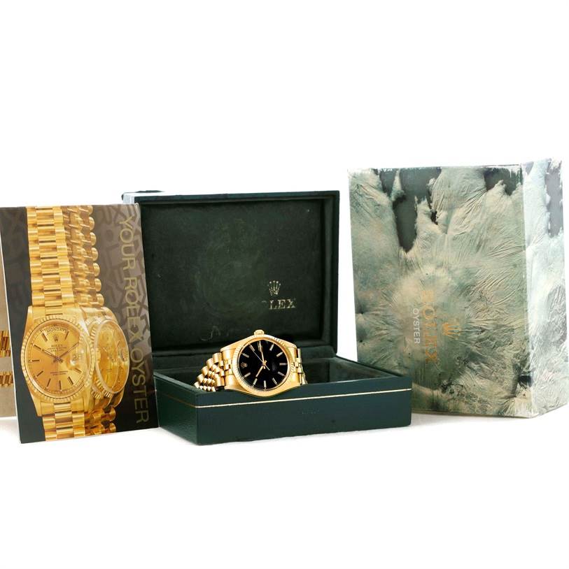 The Vintage Collection Rolex watch is displayed in its open box flanked by its packaging and a brochure.