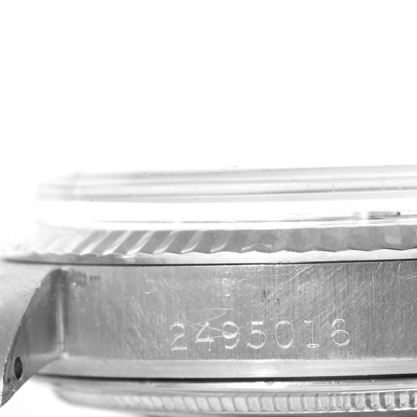 This image shows a close-up side view of a Rolex Vintage Collection 1601 Men's Stainless Steel Silver Dial 1601 Men's Stainless Steel Silver Dial watch, focusing on the casing and engraved serial number.