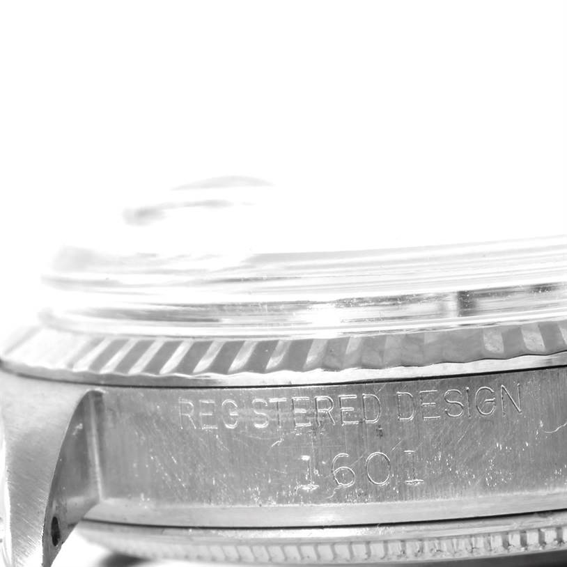 The image shows a close-up of the side and bezel of a Rolex Vintage Collection 1601 Men's Stainless Steel Silver Dial 1601 Men's Stainless Steel Silver Dial model watch.