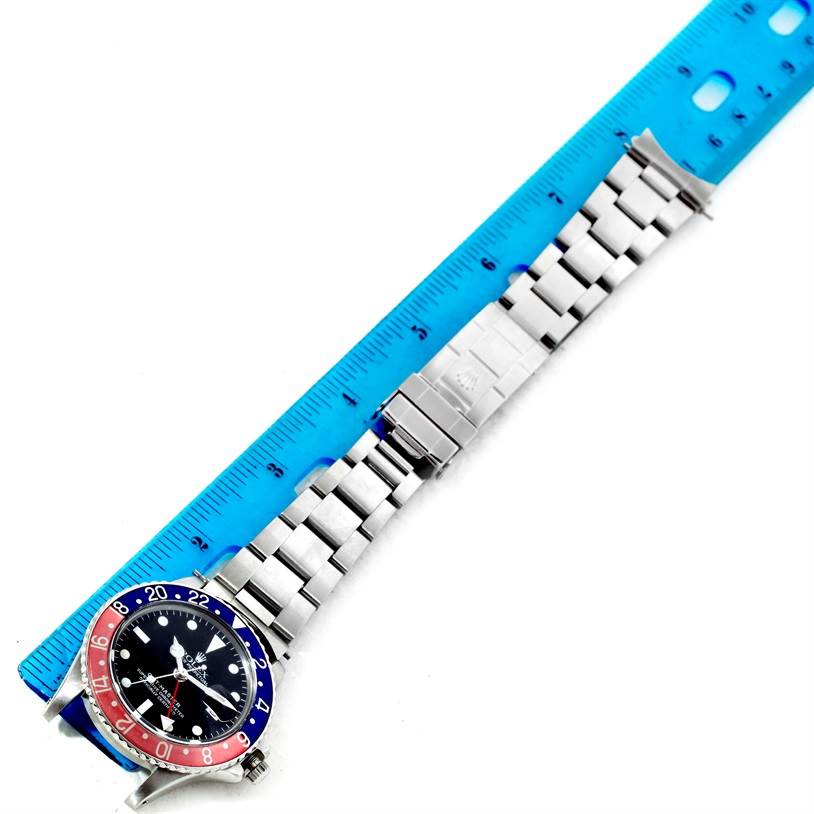 The Rolex Vintage Collection 16750 Men's Stainless Steel Black Dial 16750 Men's Stainless Steel Black Dial model is displayed flat with the face, bezel, and bracelet visible, measured against a blue ruler.