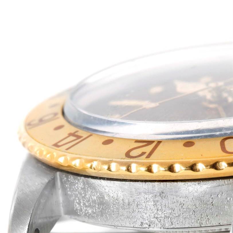 This is an angled close-up showing the bezel, crystal, and part of the case of a Rolex Vintage Collection 1675 Men
s Stainless Steel Brown Dial 1675 Men
s Stainless Steel Brown Dial watch.