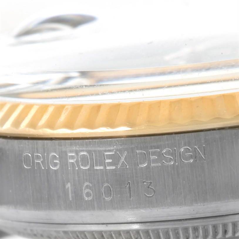 This image shows a close-up of the bezel and case side of the Vintage Collection model by Rolex with engraved text.