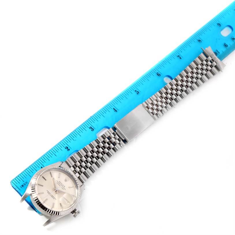 The image shows a Rolex Vintage Collection 16014 Men's Stainless Steel Silver Dial 16014 Men's Stainless Steel Silver Dial watch laid flat with a stainless steel bracelet and a blue ruler next to it for scale.