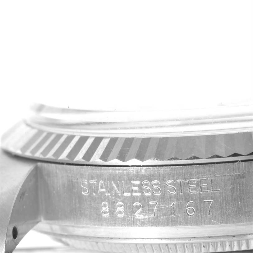 The image shows a close-up angle of the side of a Vintage Collection model by Rolex, highlighting the stainless steel case and serial number.
