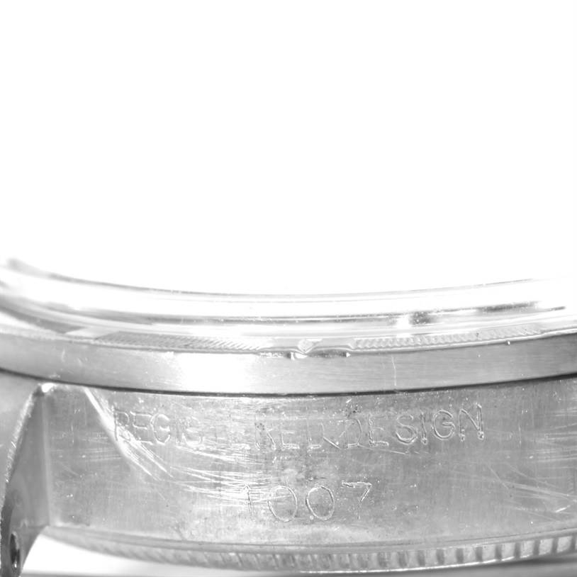 The image shows a close-up of the engraved side of the bezel and case of a Vintage Collection Rolex watch.