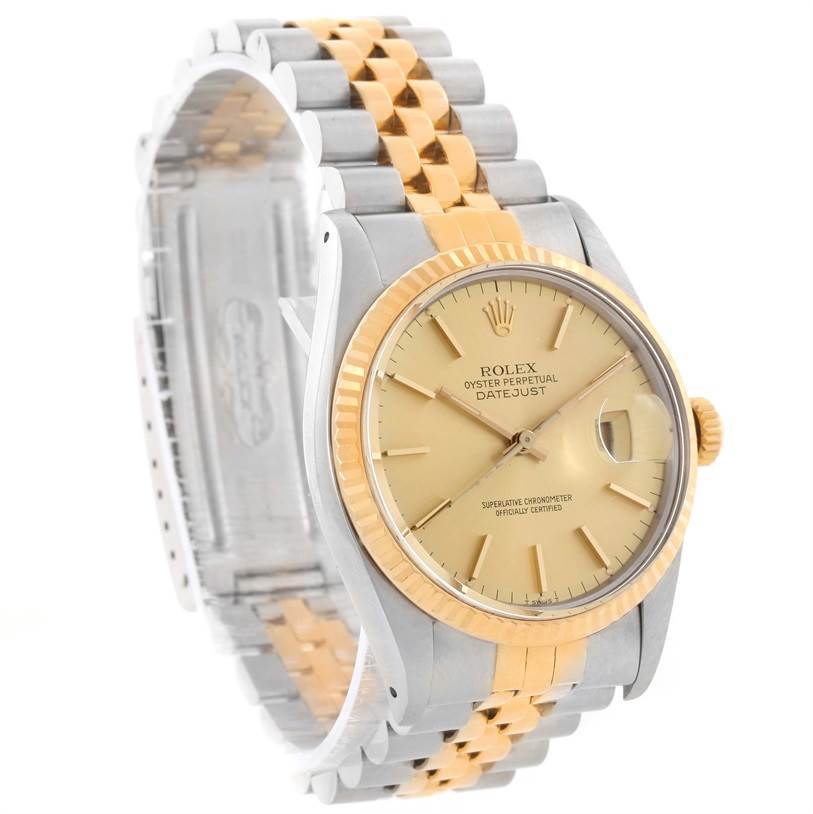This image shows a Rolex Vintage Collection 16013 Men
s Stainless Steel Champagne Dial 16013 Men
s Stainless Steel Champagne Dial Datejust watch at an angle, highlighting its gold dial, two-tone bracelet, and fluted bezel.