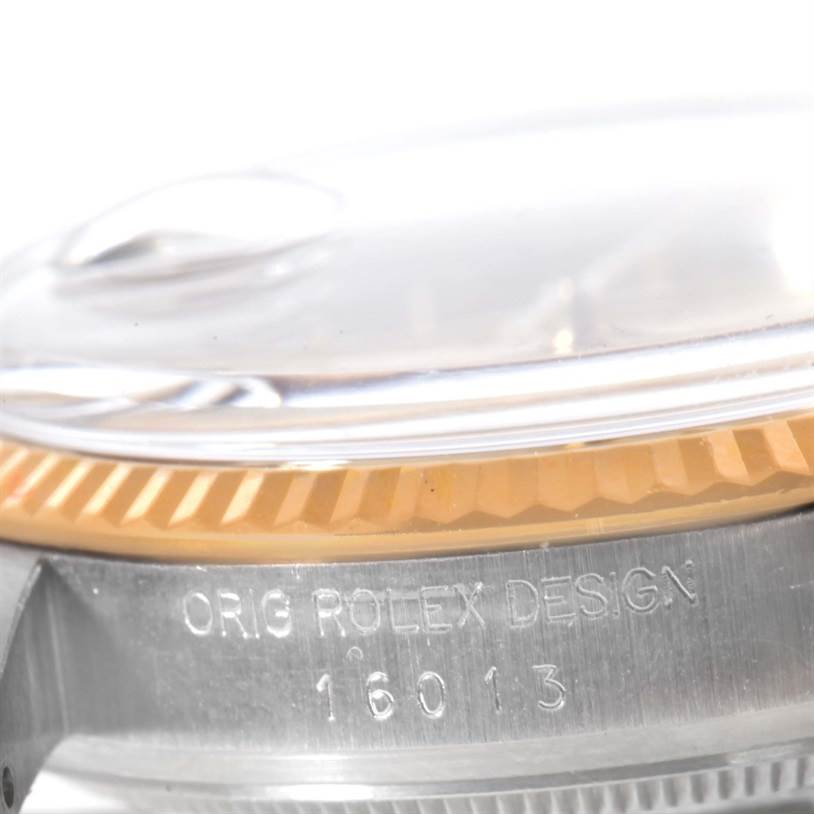 The image shows a close-up of the side of a Rolex Vintage Collection 16013 Men
s Stainless Steel Champagne Dial 16013 Men
s Stainless Steel Champagne Dial watch case with the engraved model number "16013."