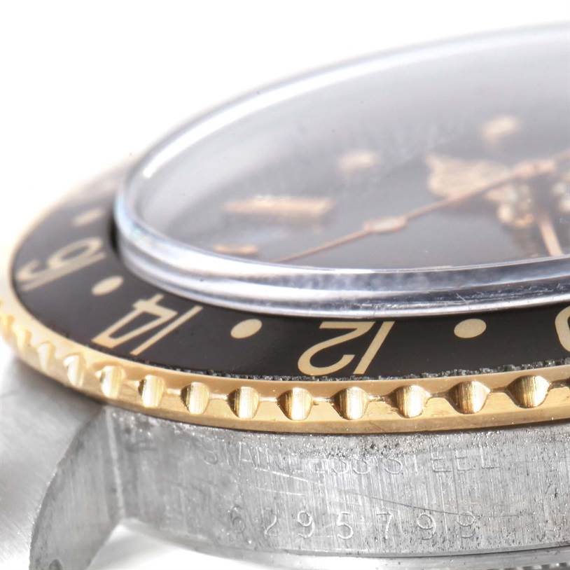 This image shows a close-up angle of the bezel, crystal, and part of the case of a Rolex Vintage Collection 16753 Men's Stainless Steel Black Dial 16753 Men's Stainless Steel Black Dial watch.