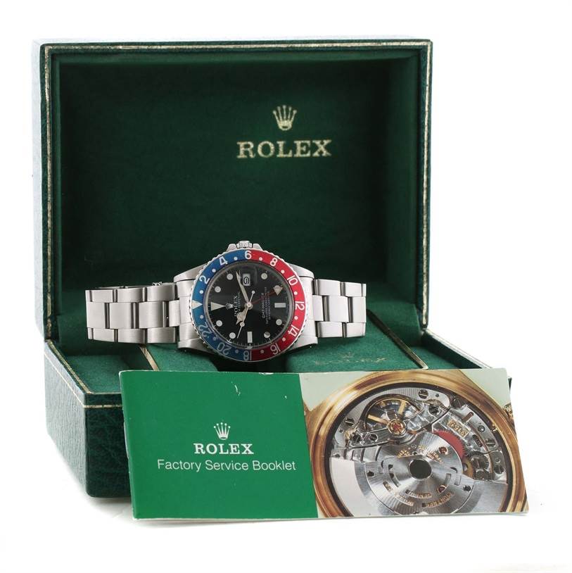 The Vintage Collection model by Rolex is shown from the front, positioned in its display box with a factory service booklet.