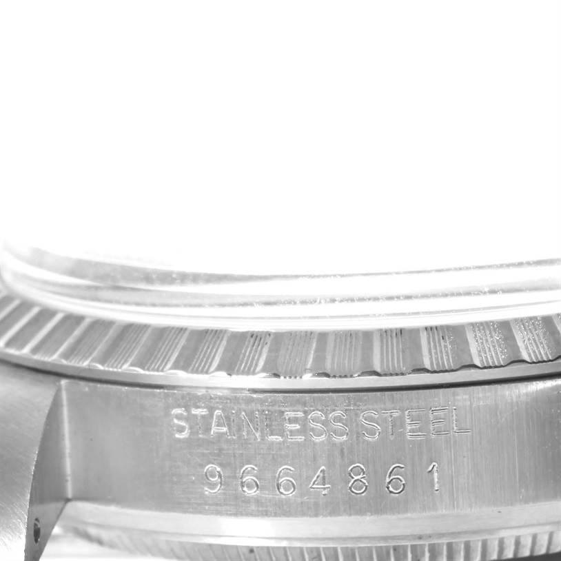 This image shows a close-up of the side and bezel of a Rolex Vintage Collection 16030 Men's Stainless Steel Silver Dial 16030 Men's Stainless Steel Silver Dial watch, highlighting the stainless steel stamp and serial number.