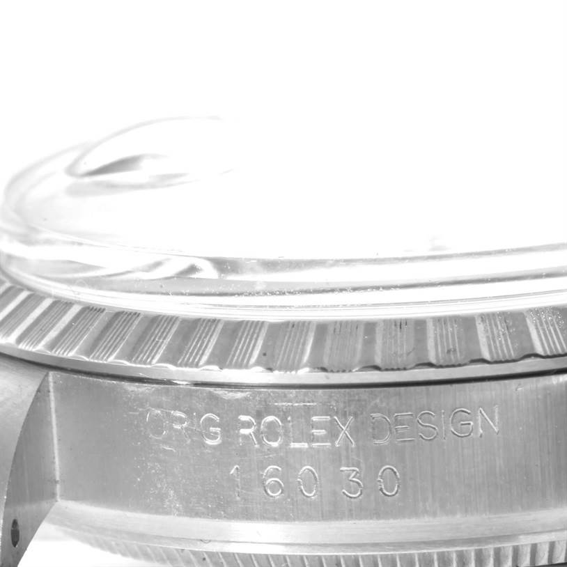 The image shows a close-up side angle of the Rolex Vintage Collection 16030 Men's Stainless Steel Silver Dial 16030 Men's Stainless Steel Silver Dial model, highlighting the watch's bezel and case with engraved text.