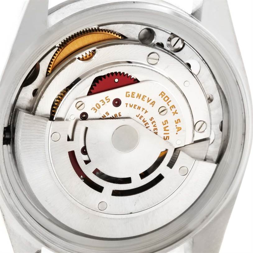 This is a close-up view of the internal movement of a Vintage Collection Rolex, showcasing gears and the rotor.