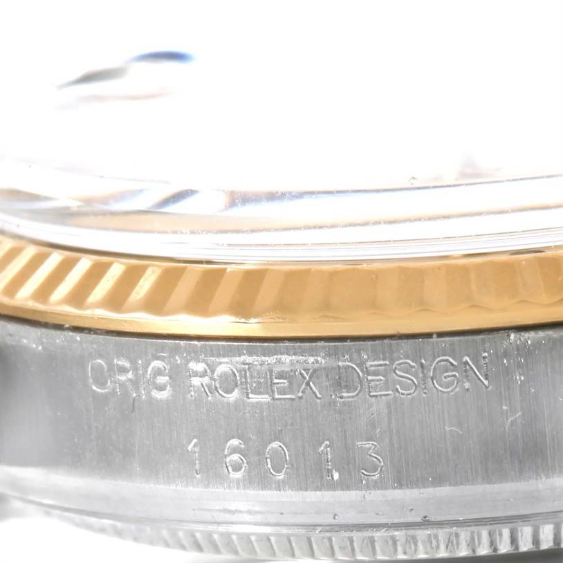 The image shows a close-up of the side of a Rolex Vintage Collection 16013 Men
s Stainless Steel Champagne Dial 16013 Men
s Stainless Steel Champagne Dial watch, highlighting the bezel and case with engraved model number 16013.