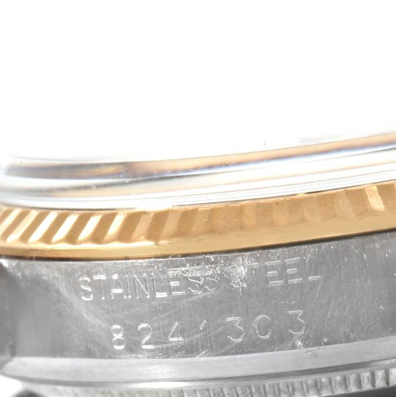 The image shows a close-up of the side of a Vintage Collection Rolex watch, highlighting its stainless steel case, serial number, and part of the bezel.