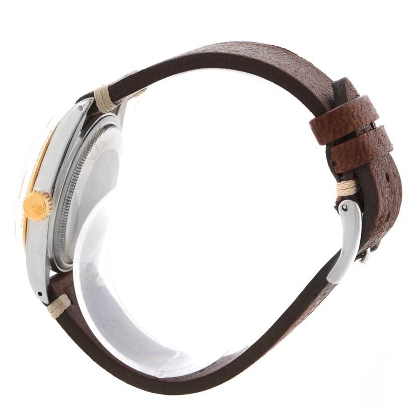 Side view of a Rolex Vintage Collection 16013 Men
s Stainless Steel Champagne Dial 16013 Men
s Stainless Steel Champagne Dial watch showing the case, crown, and leather strap.