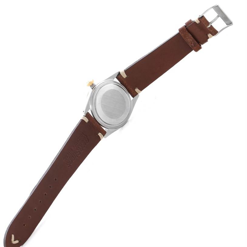 The image shows the back view of a Rolex Vintage Collection 16013 Men
s Stainless Steel Champagne Dial 16013 Men
s Stainless Steel Champagne Dial watch with a brown leather strap.