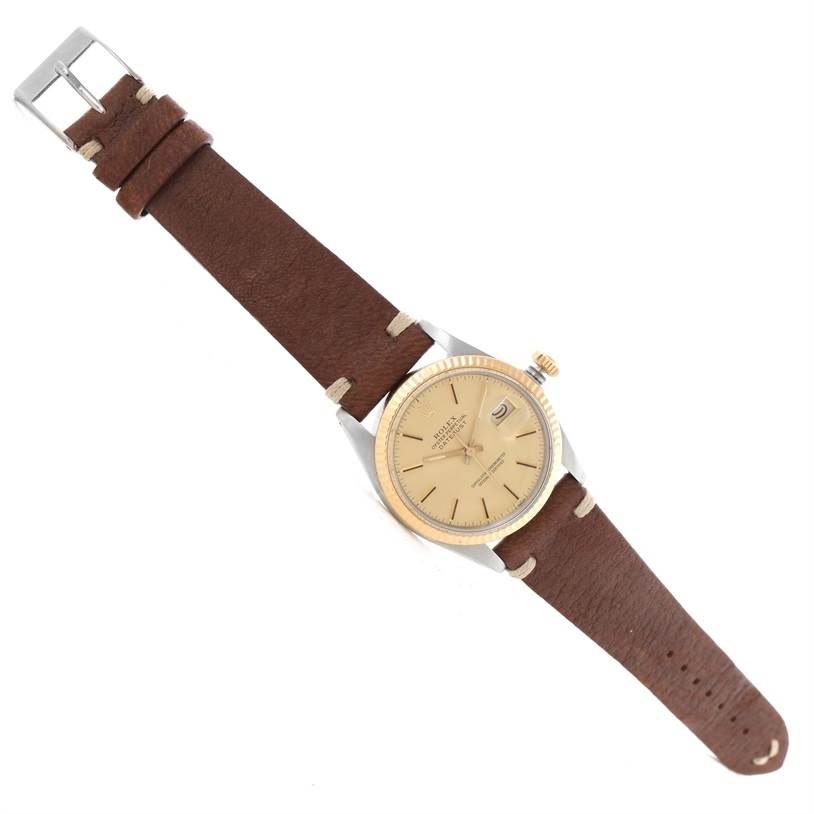 The image shows a top view of a Rolex Vintage Collection 16013 Men
s Stainless Steel Champagne Dial 16013 Men
s Stainless Steel Champagne Dial model with a brown leather strap and a beige dial.