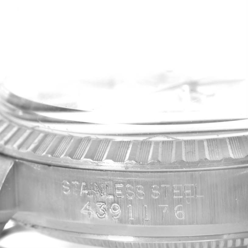 The image shows a close-up of the serial number and stainless steel inscription on the side of a Rolex Vintage Collection 1603 Men's Stainless Steel Silver Dial 1603 Men's Stainless Steel Silver Dial watch.