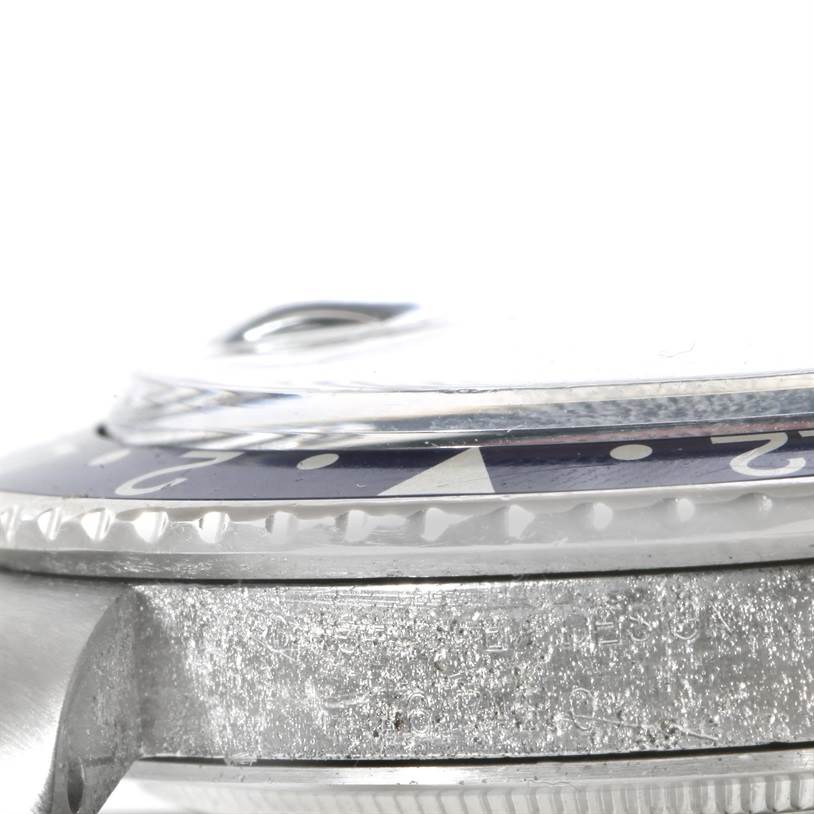 The image shows a close-up side view of the bezel and case of a Vintage Collection Rolex watch.