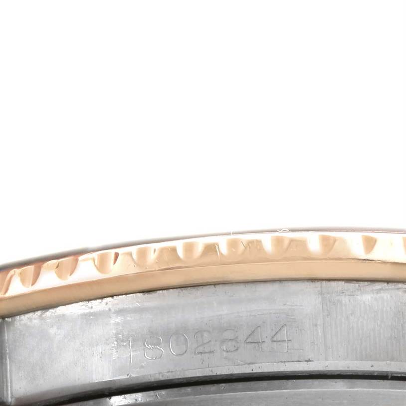 This close-up image shows the engraved serial number on the rim and part of the bezel of the Vintage Collection model by Rolex.