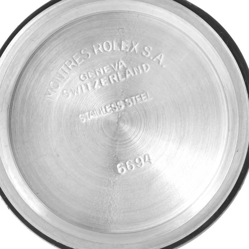 This image shows the interior of the back case of a Vintage Collection Rolex watch, with engraved markings.