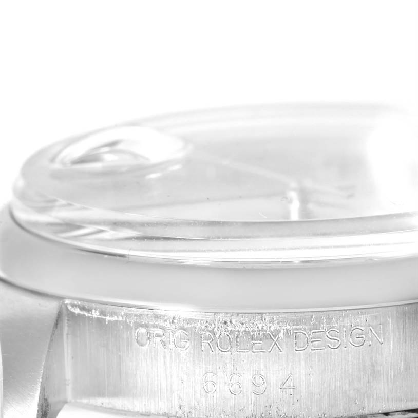 This image of the Vintage Collection model by Rolex shows a close-up of the side profile, focusing on the bezel, crystal, and engraved text.