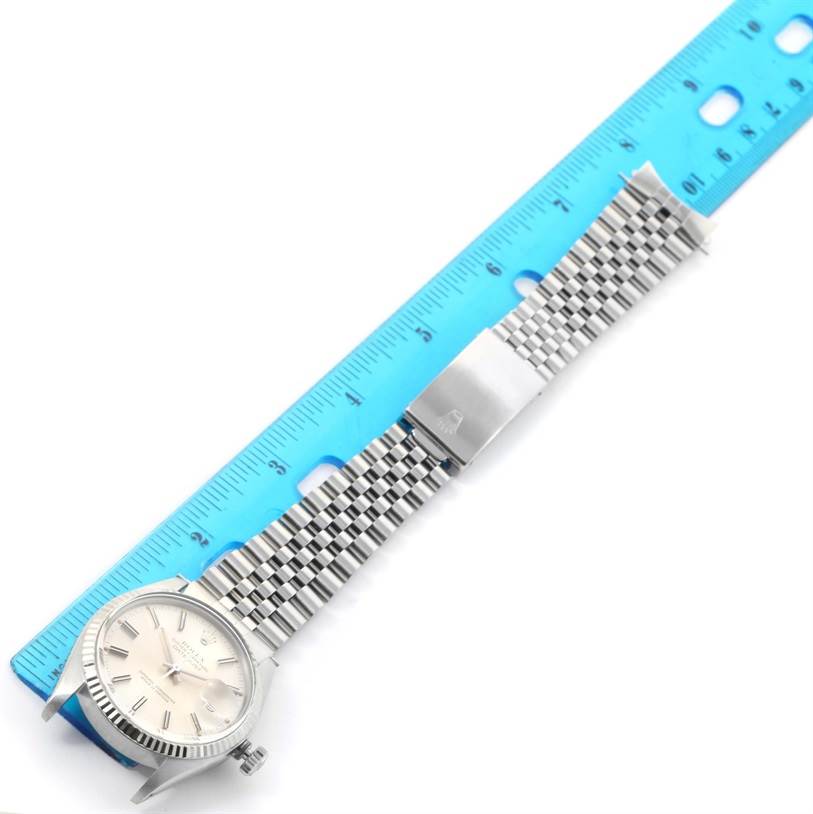 The image shows a Rolex Vintage Collection 16014 Men's Stainless Steel Silver Dial 16014 Men's Stainless Steel Silver Dial watch laid flat next to a ruler, displaying the face and the metal bracelet.