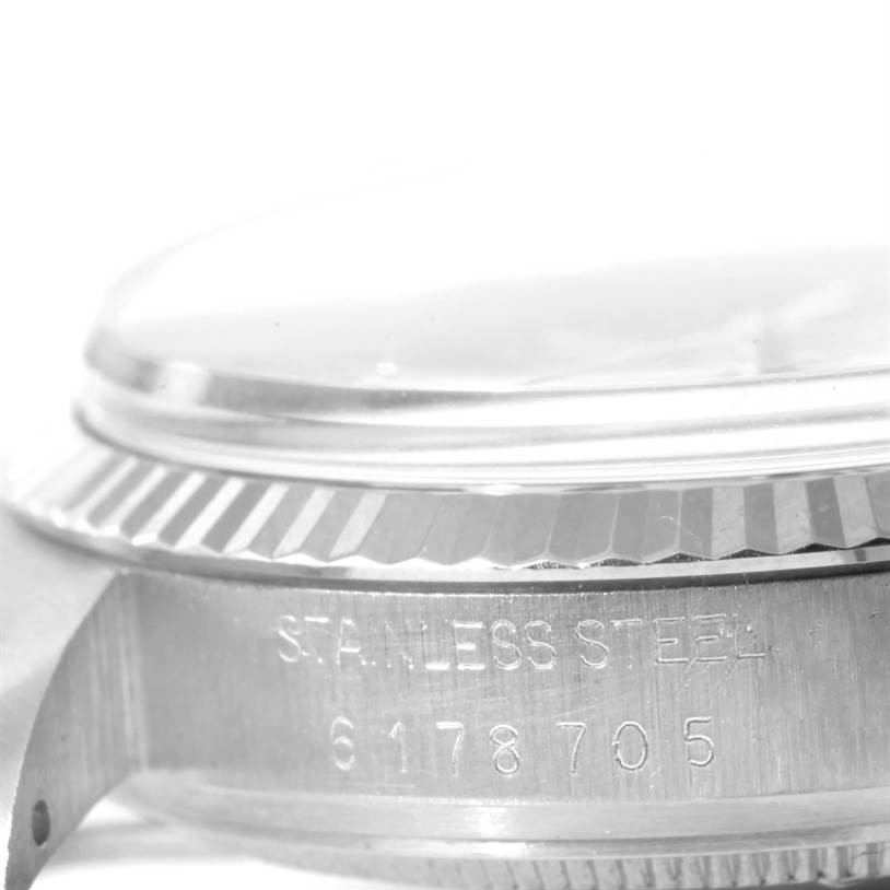 This image shows a close-up side view of the Rolex Vintage Collection 16014 Men's Stainless Steel Silver Dial 16014 Men's Stainless Steel Silver Dial watch focusing on the serial number engraving and bezel.