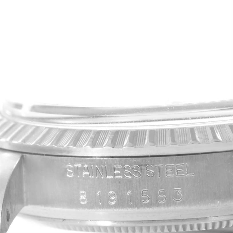 This photo shows a close-up of the side of a Rolex Vintage Collection 16030 Men's Stainless Steel Silver Dial 16030 Men's Stainless Steel Silver Dial watch, focusing on the stainless steel case and its serial number.
