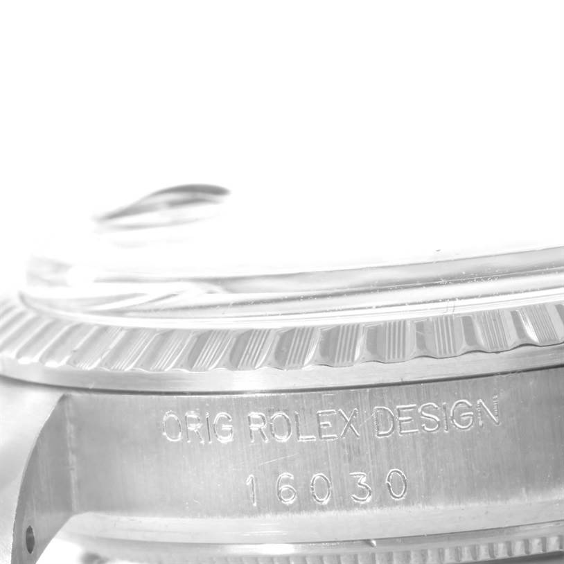 The image shows a close-up side view of a Rolex Vintage Collection 16030 Men's Stainless Steel Silver Dial 16030 Men's Stainless Steel Silver Dial watch, highlighting the case and engravings.