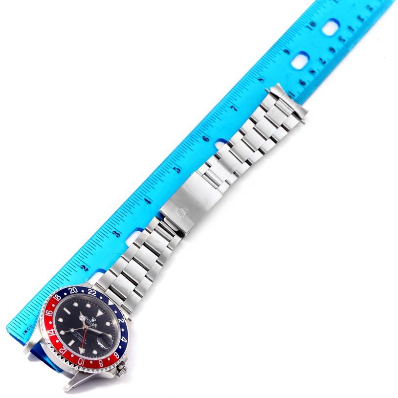 The image shows a Rolex Vintage Collection 16760 Men's Stainless Steel Black Dial 16760 Men's Stainless Steel Black Dial watch laid flat with a blue ruler measuring its bracelet length.