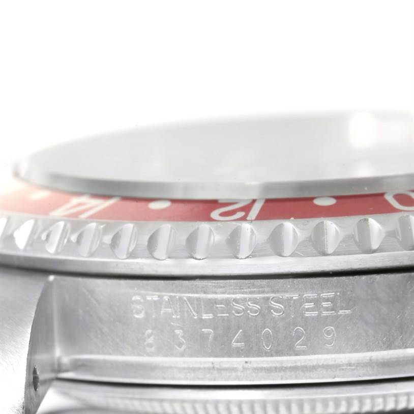 This close-up angle of the Rolex Vintage Collection 16760 Men's Stainless Steel Black Dial 16760 Men's Stainless Steel Black Dial watch shows the bezel and part of the stainless steel case.