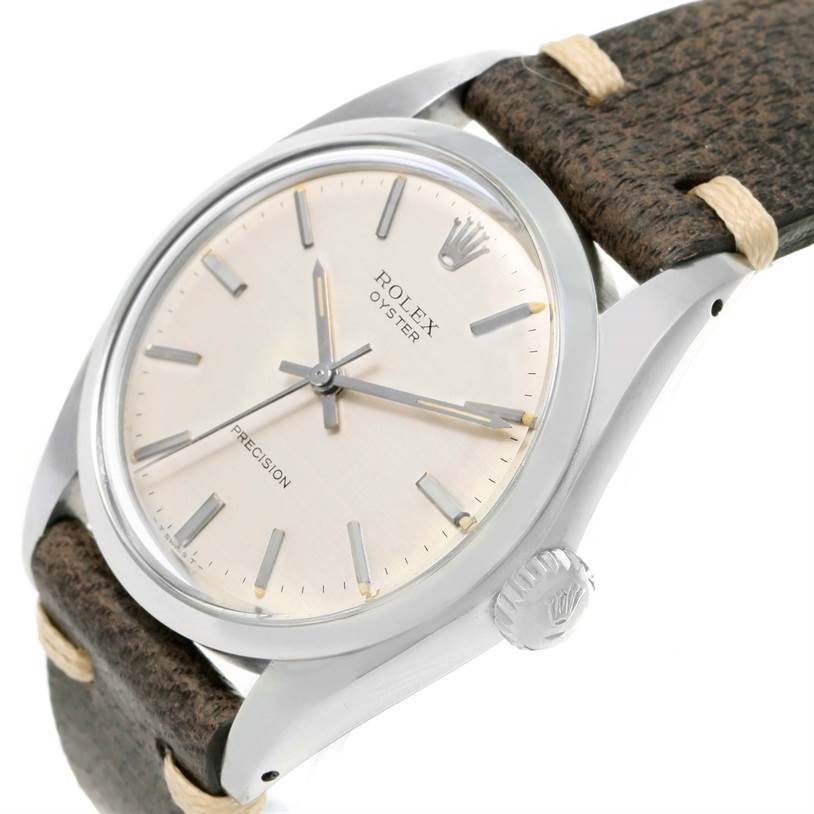 The image shows the Rolex Vintage Collection 6426 Men's Stainless Steel Silver Dial 6426 Men's Stainless Steel Silver Dial model at an angled close-up, featuring its dial, crown, and brown leather strap.