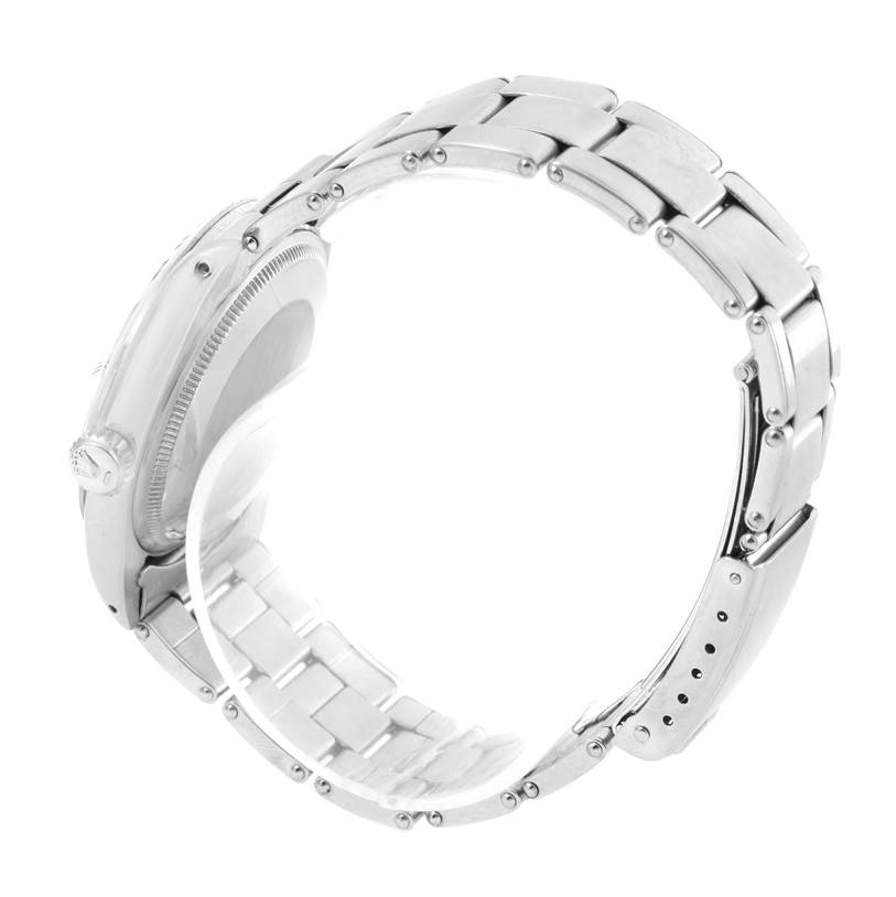 The image shows a side view of a Rolex Vintage Collection 1500 Men's Stainless Steel Silver Dial 1500 Men's Stainless Steel Silver Dial watch, focusing on its case, bezel, and bracelet.