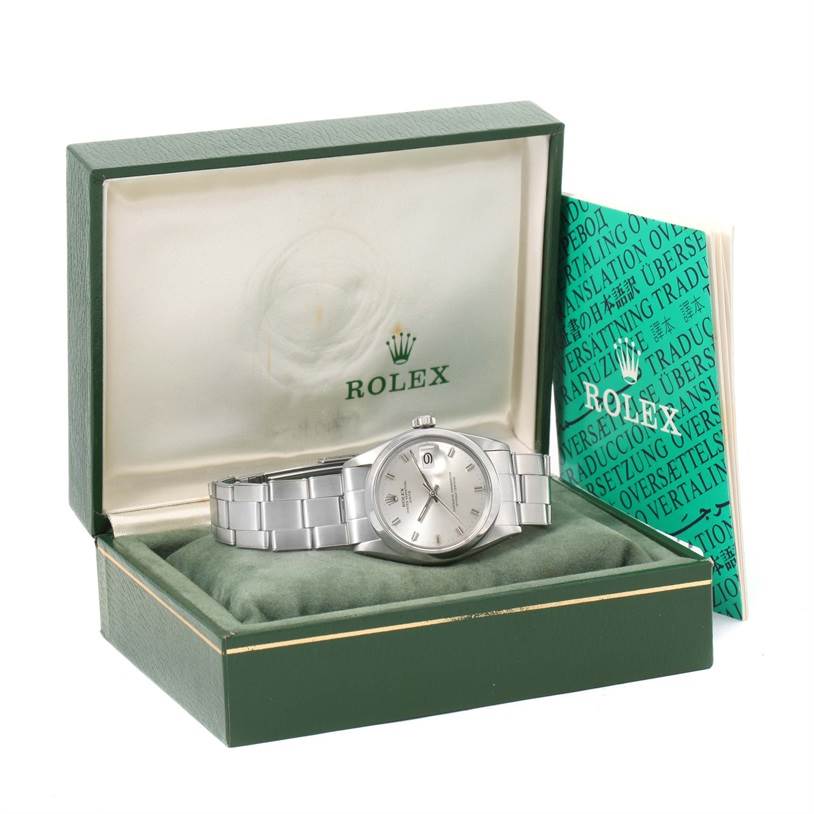 The image shows a Rolex Vintage Collection 1500 Men's Stainless Steel Silver Dial 1500 Men's Stainless Steel Silver Dial watch in its open box, alongside a green instruction manual.