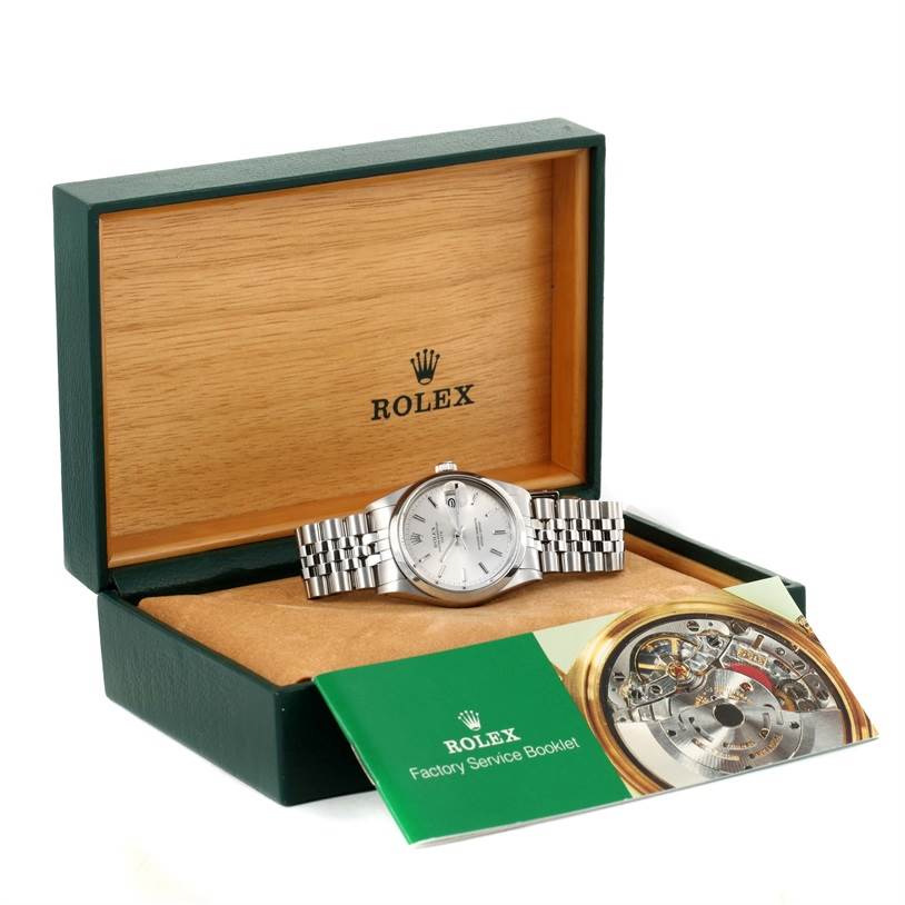 This image shows a Rolex Vintage Collection 15000 Men's Stainless Steel Silver Dial 15000 Men's Stainless Steel Silver Dial watch at an angle in an open box with the Rolex Factory Service Booklet.