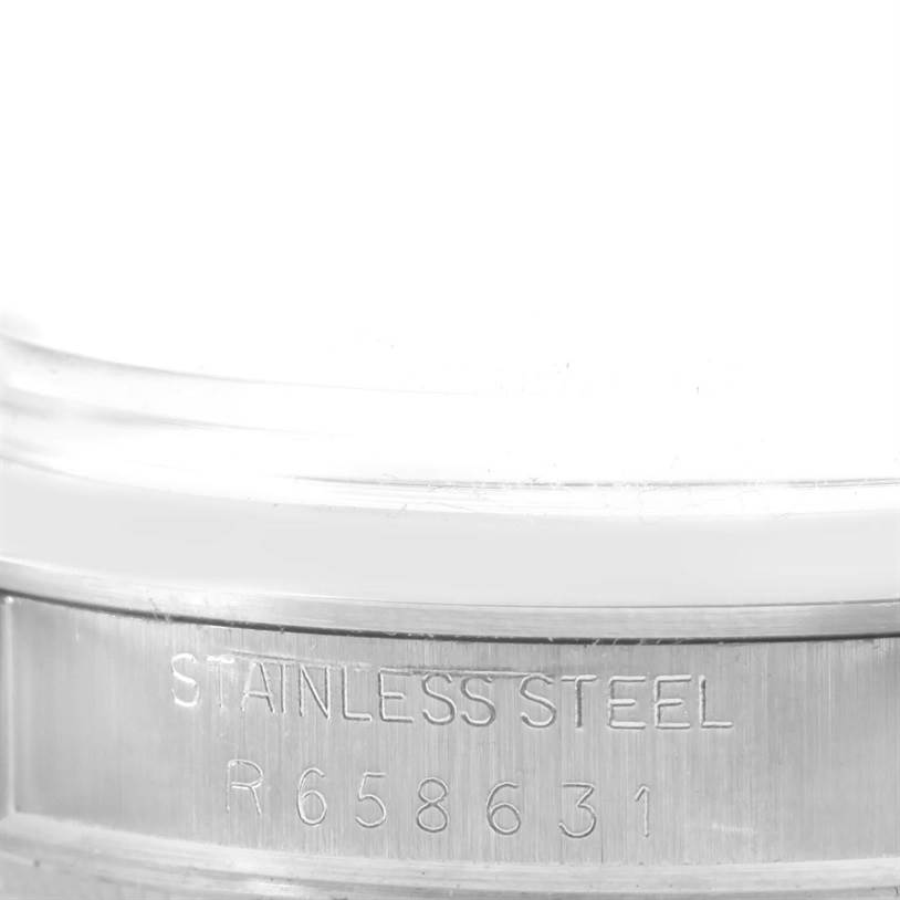 This image shows a close-up of the serial number and "STAINLESS STEEL" engraving on the case of a Vintage Collection Rolex watch.