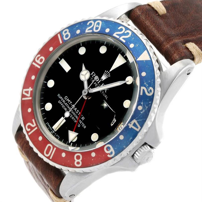The Vintage Collection Rolex watch is shown at an angle, displaying the face, crown, bezel, and a portion of the strap.