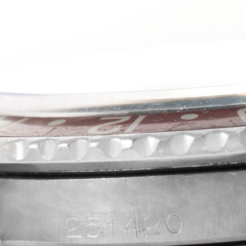 This close-up image of the Rolex Vintage Collection 1675 Men's Stainless Steel Black Dial 1675 Men's Stainless Steel Black Dial model shows the bezel, crystal edge, and part of the case with visible engraving.